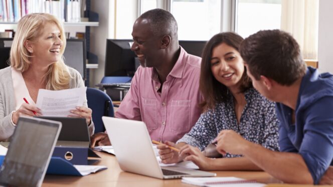 Group Of Mature College Students Collaborating On Project