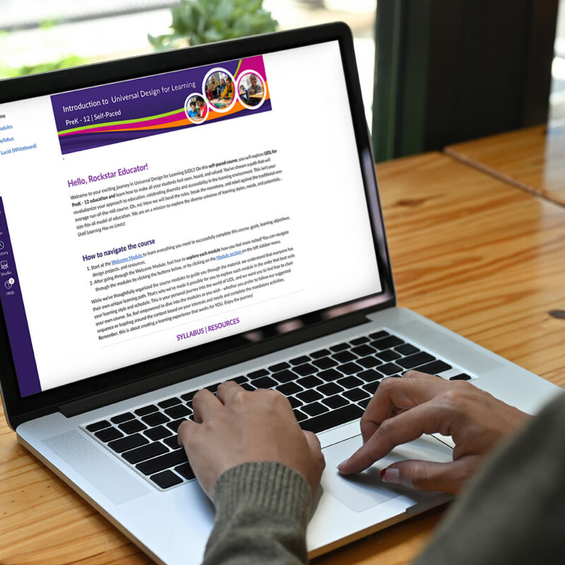 Woman using a laptop with the Introduction to UDL course visible on the screen
