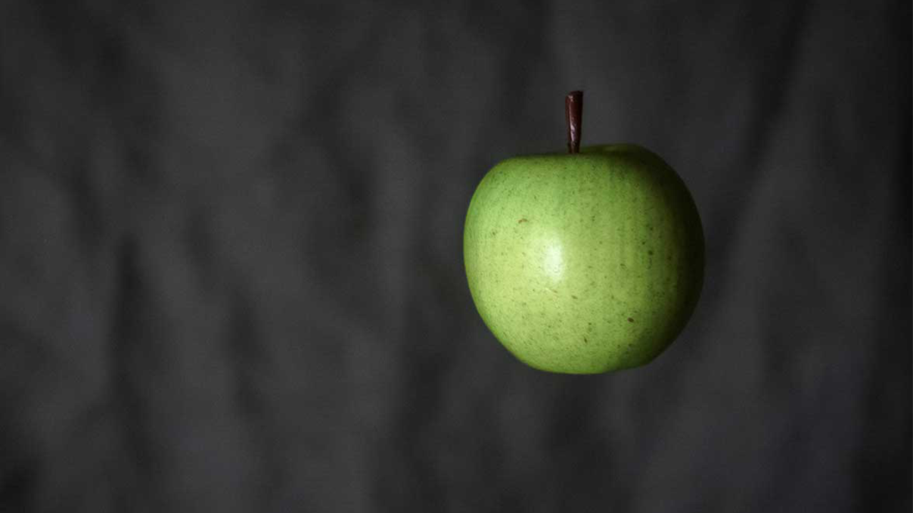 Photo of a green apple on black background